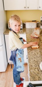 Child helping fix food in the kitchen